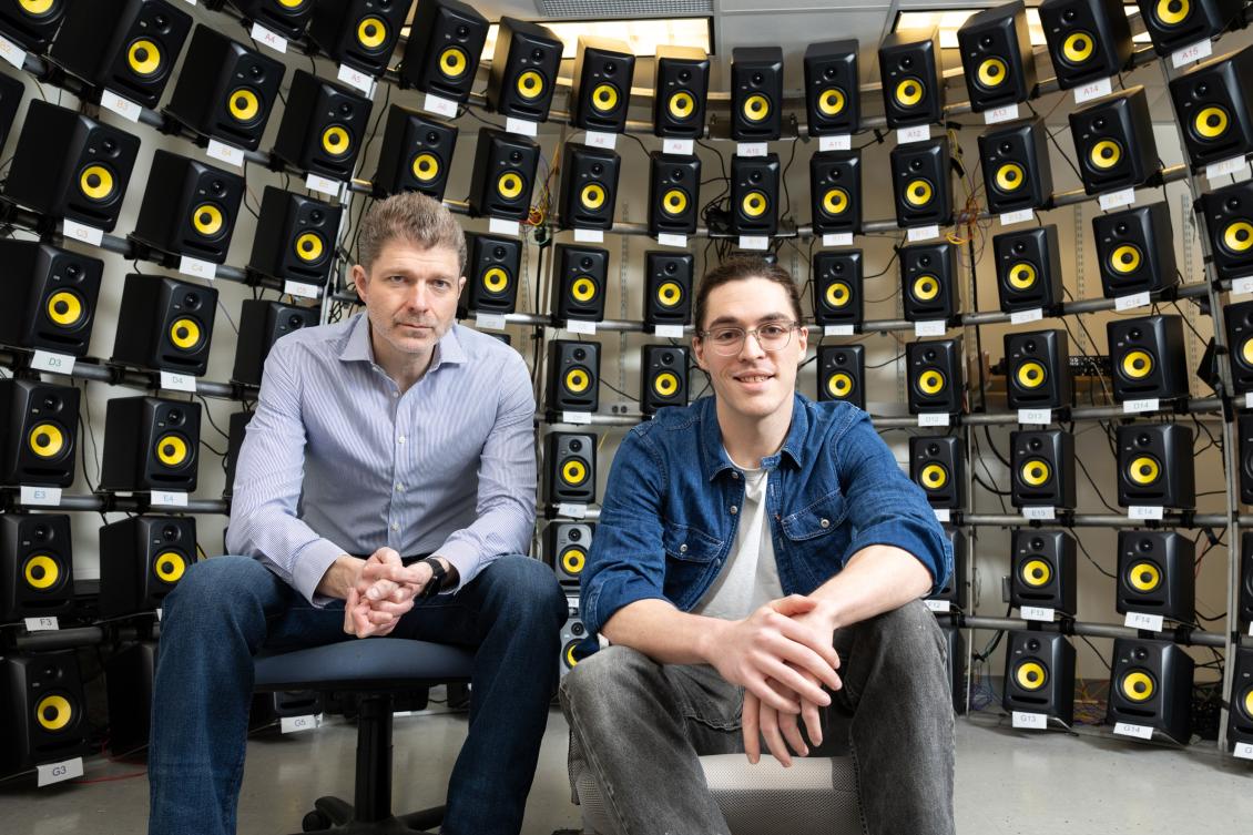 Josh McDermott (left), professor of brain and cognitive sciences and associate investigator at the McGovern Institute sits with graduate student Ian Griffith in the speaker array room where they conducted the study.